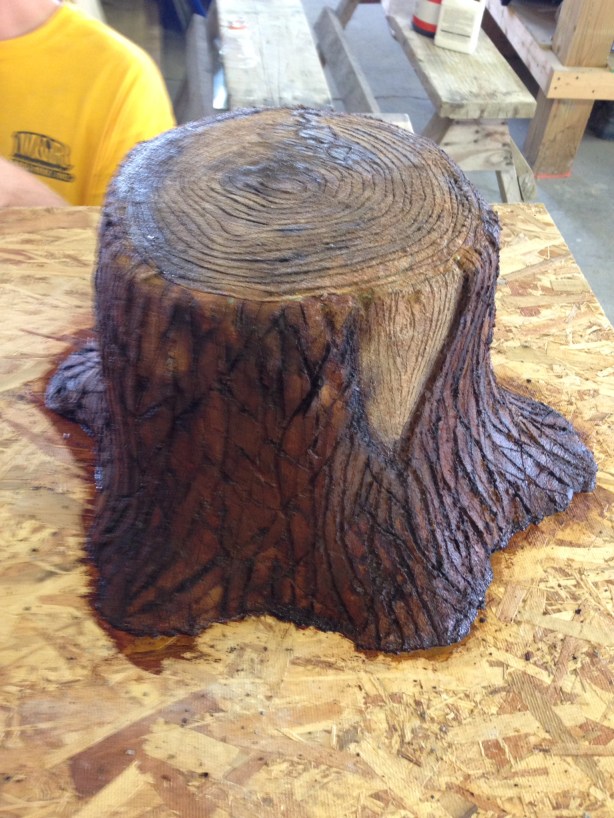 Custom lightweight concrete sewer clean out cover made to look like tree stump